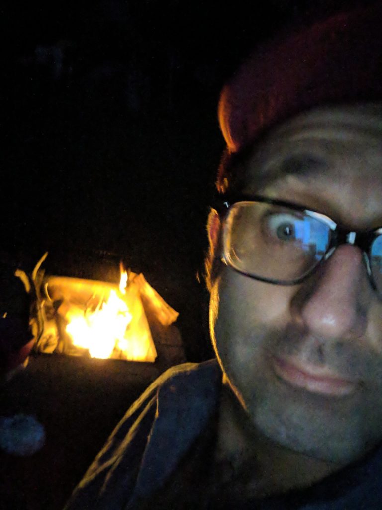 photo of Zach in front of the fire