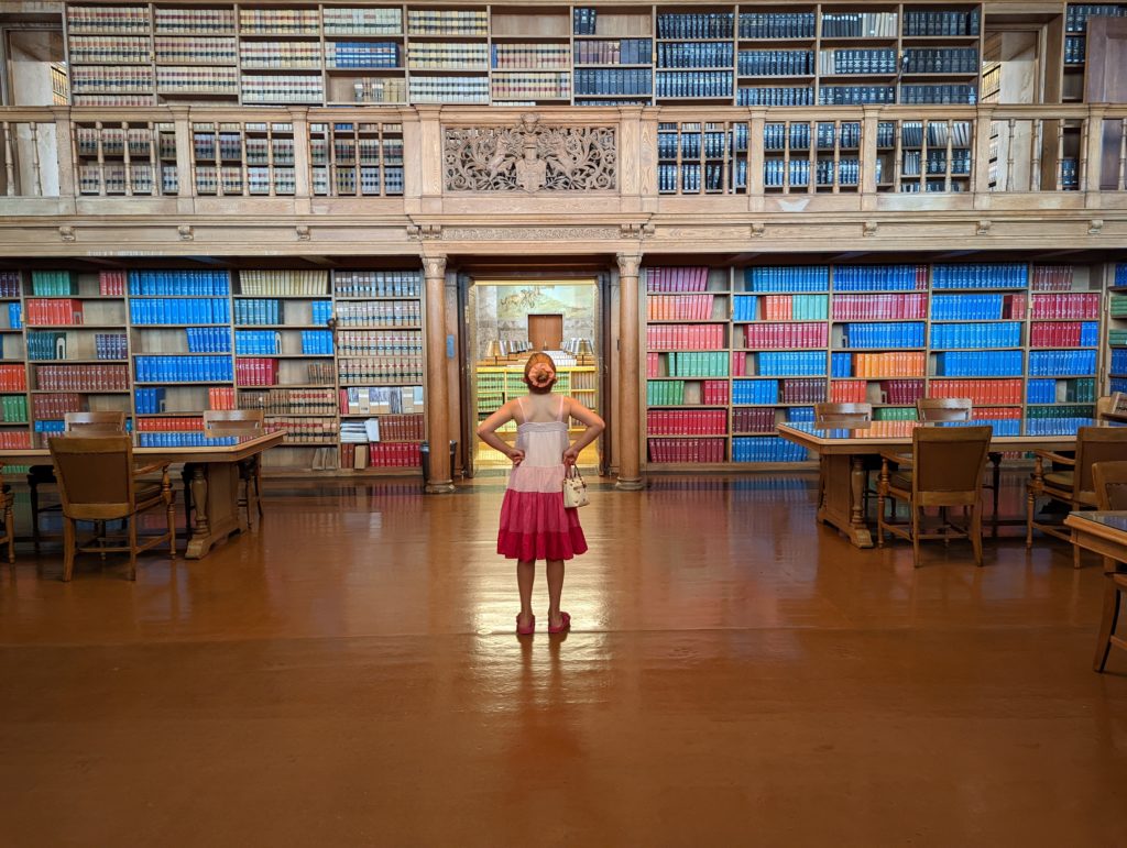 photo of Ada in front of a wall of books in the Nebraska capitol law library