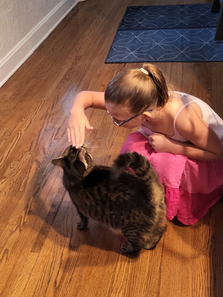 photo of Ada petting a cat