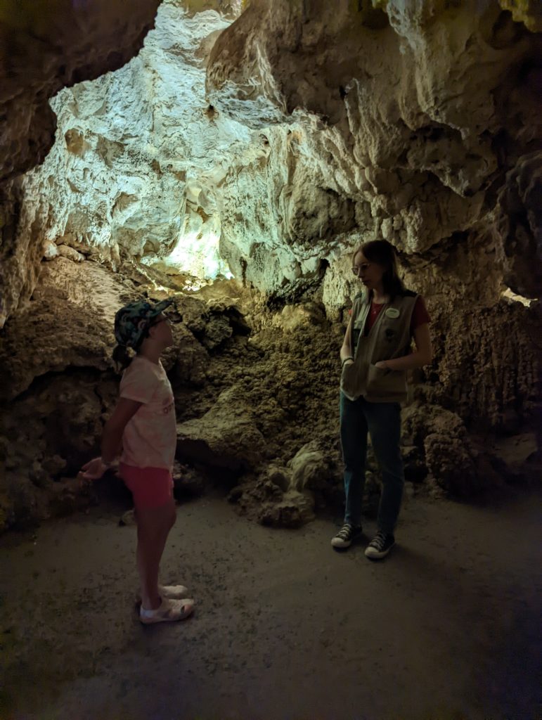 photo of Ada inside a cavern talking to the tour guide