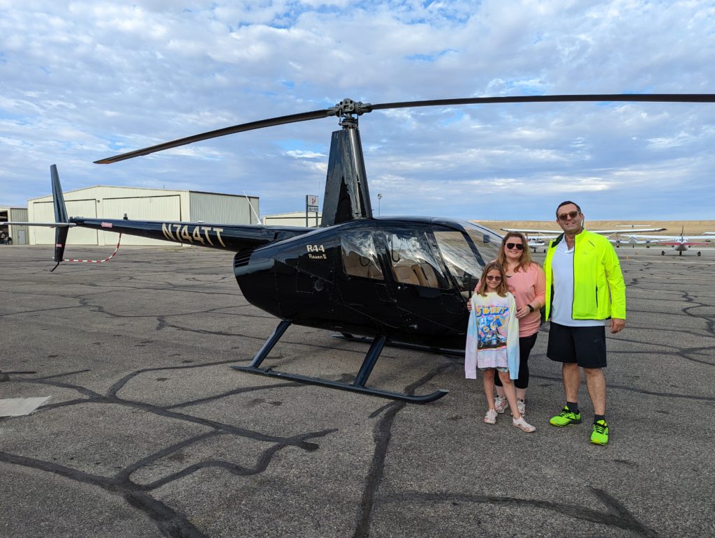 photo of Ada, Zach, and Beth in front of a helicopter