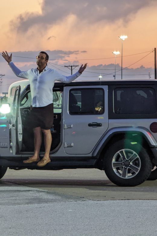 photo of Zach standing on the running boards of his new Jeep