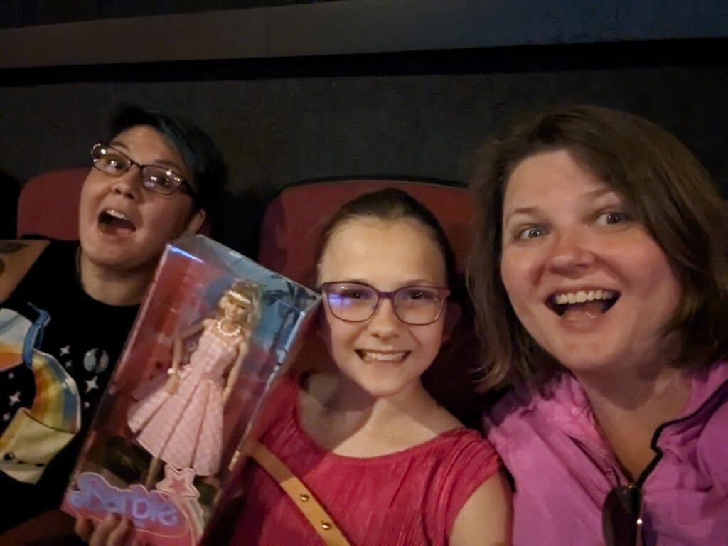 photo of three people attending the Barbie movie